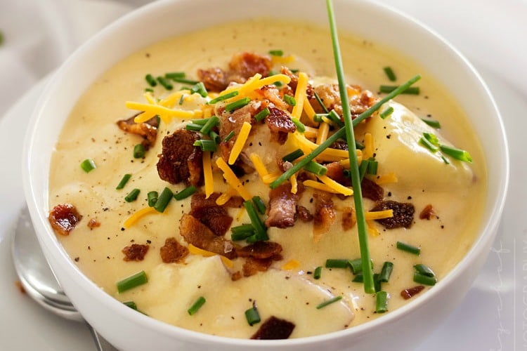 Copycat loaded potato soup topped with cheddar cheese, crumbled bacon and fresh chives.