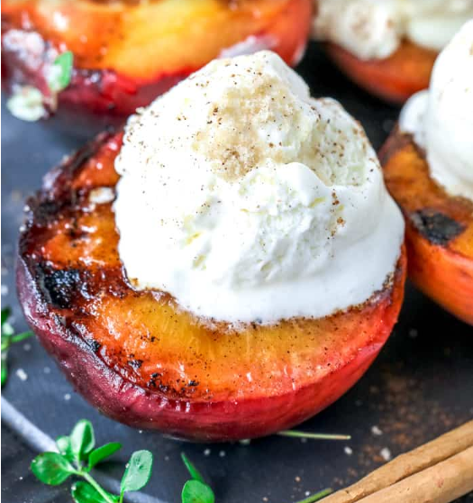 Brown sugar grilled peaches with a scoop of vanilla ice cream on top
