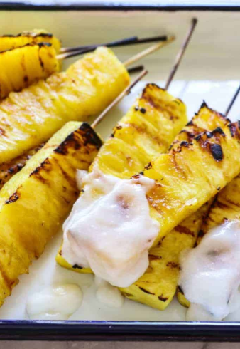 Sweet and juicy caramelized grilled pineapple drizzled with a creamy coconut rum sauce