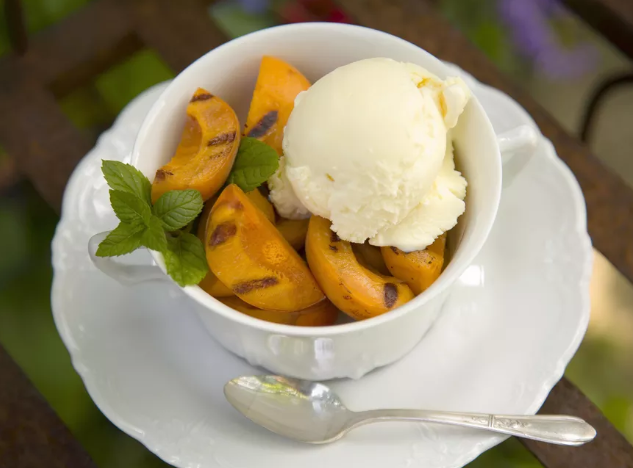 Grilled apricots and honey with a scoop of ice cream