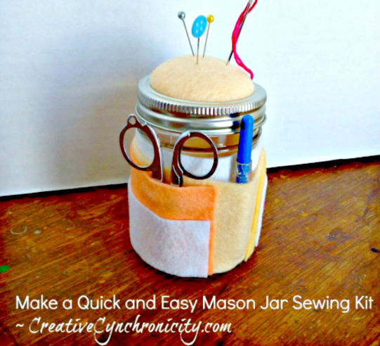 mason jar sewing kit with felt pincushion on top and felt pockets around the sides