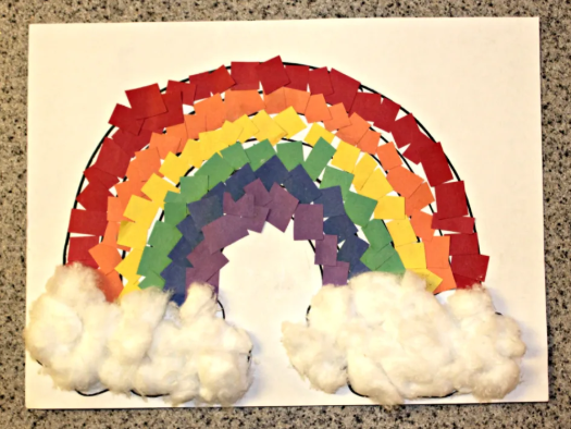 Rainbow paper crat made from construction paper with cotton balls on both end sides that looks like clouds