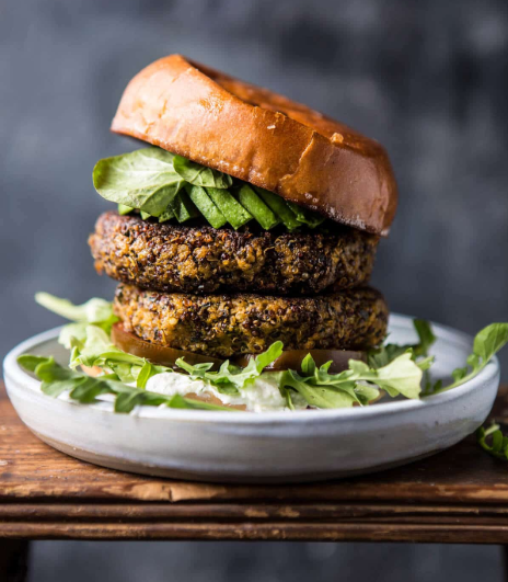 Roasted zucchini burger with garlic whipped feta and some leafy vegetables