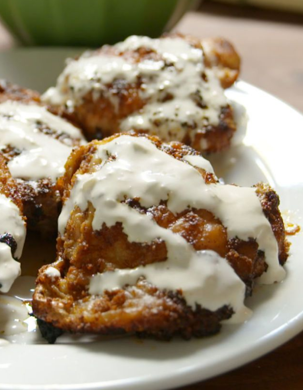 Chicken thighs drizzled with white barbeque sauce