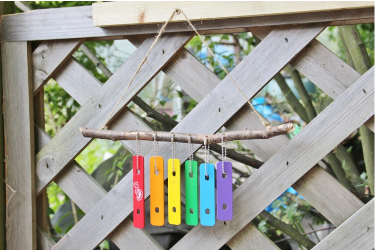 Xylophone wind chimes hang on a wall
