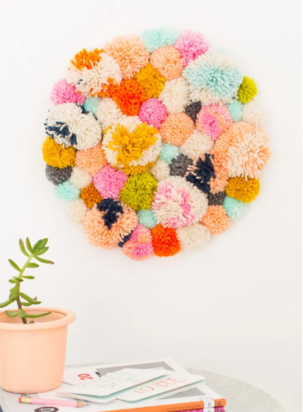 A beautiful yarn pompom wall hanging 