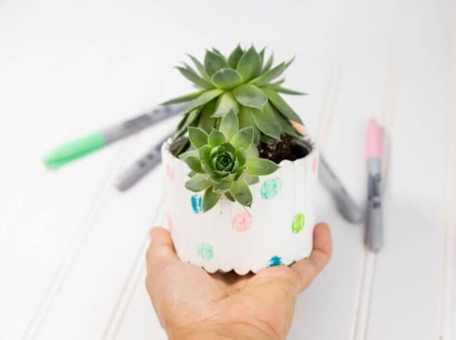 A homemade planter craft tutorial made of popsicle sticks for kids