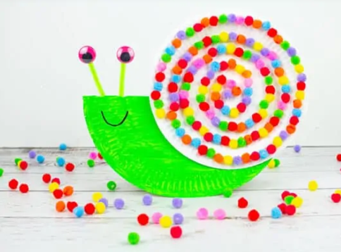Adorable rocking snails with googly eyes and colorful pom pom spiral shell.