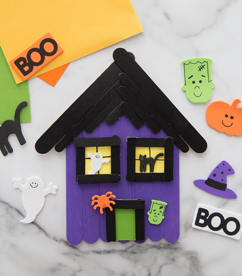 A popsicle stick haunted house craft for kids perfect for holloween