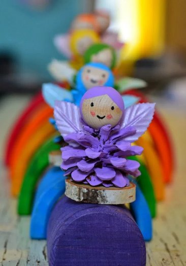 Rainbow fairies made from pinecones 