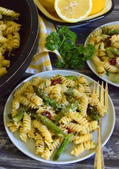 roasted asparagus lemon butter pasta salad tossed with sun dried tomatoes, fresh lemon, and parmesan