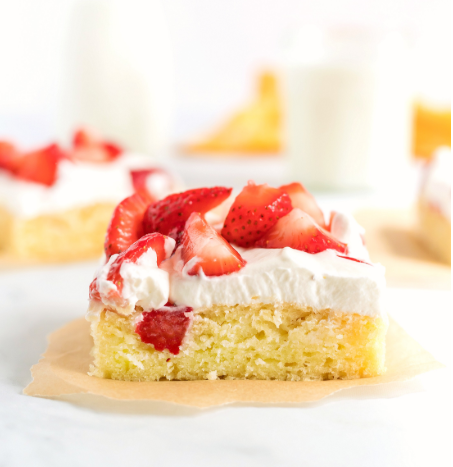a delicious, moist and tender slab strawberry shortcake smothered in homemade whipped cream and fresh sliced strawberries