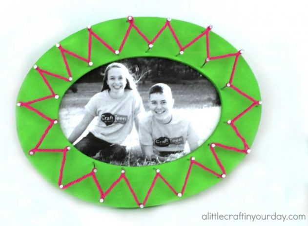 A string art frame with a photo of Tanner and Courtney