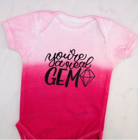Dip dyed iron on baby onesie with a text saying you're a real gem