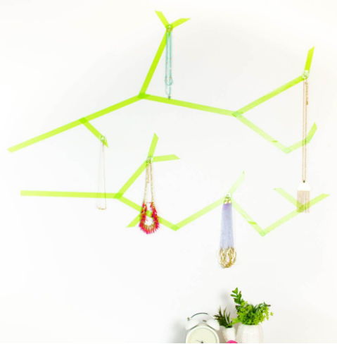 Diy jewelry tree made with simple green Washi Tape and damage free adhesive wall hooks perfect place to hang your jewelry while still saving space in your doom