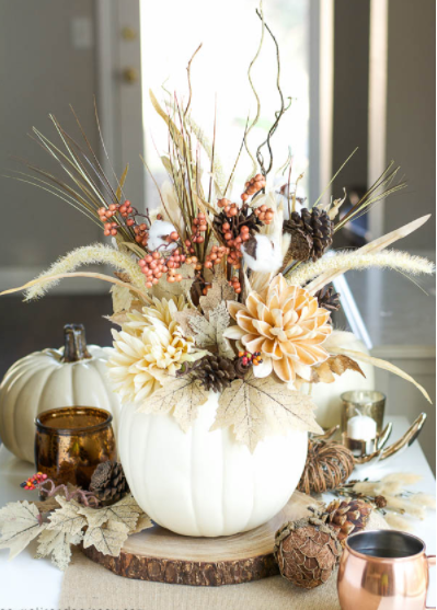 Pumpkin vase with pink and burgundy flower arrangement