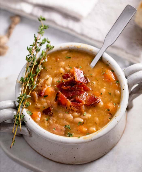 Slow cooker ham and bean soup. made with navy beans and delicious bites of ham in a thick and flavorful broth