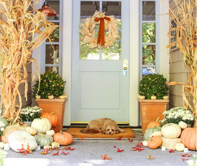 neutral fall porch decor with pumpkins and cornstalks holiday craft