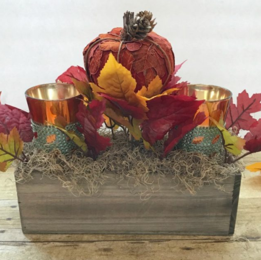 cute little leafy pumpkin with fall leaves and candles centerpiece