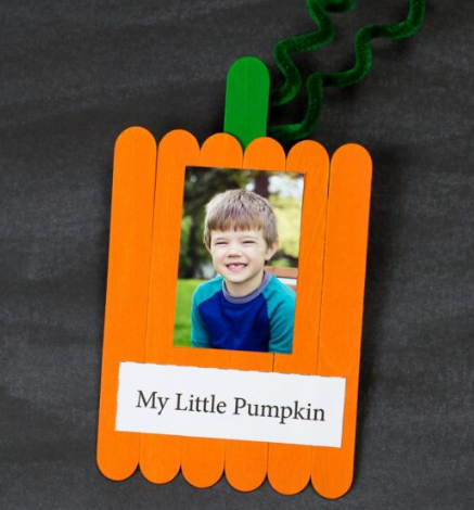 Popsicle stick pumpkin keepsake with a cute photo of a boy on it and a text saying My Little Pumpkin