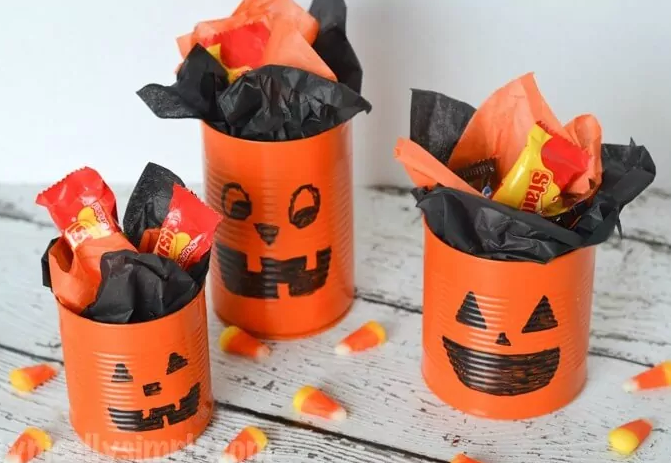 Tin can pumpkins with Halloween treats inside