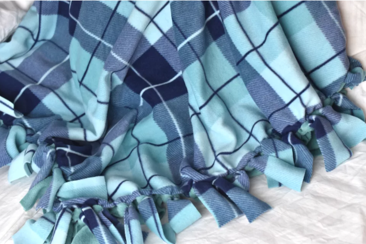 Stripe color blue fleece blanket with a tied fringe edge