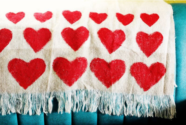 Throw blanket with a heart shapes painted to it