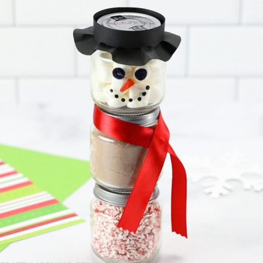 A hot cocoa ingredients put on a snowman like jars