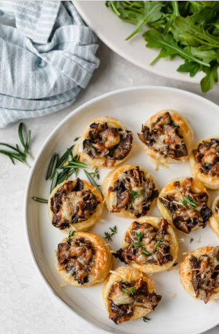 A plate of cheesy mushroom tartlets 