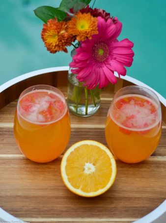 A couple of orange watermelon mocktails on a glasses