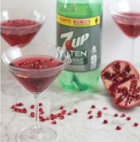 Pomegranate martini mocktails on a glass with pomegranate seeds on them