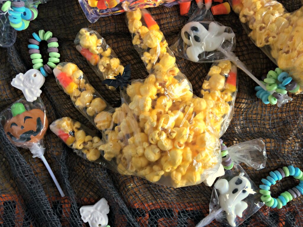 Popcorn witch hand and Halloween candies