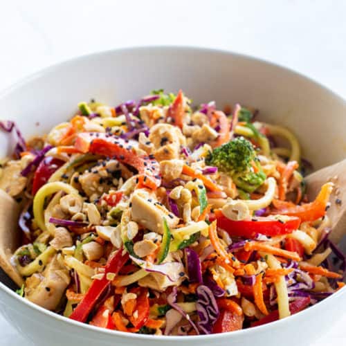 A bowl of Thai Chicken Veggie noodle salad with creamy peanut dressing