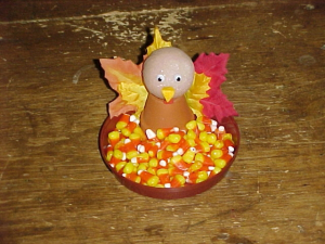 clay pot turkey with tray of candy corn centerpiece