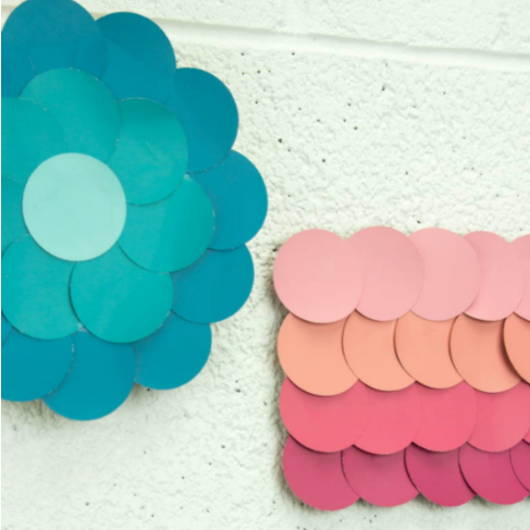 Paint chip wall art that looks like a big shades of blue flower