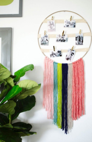 Yarn wall hanging on the hoop with photo display on it