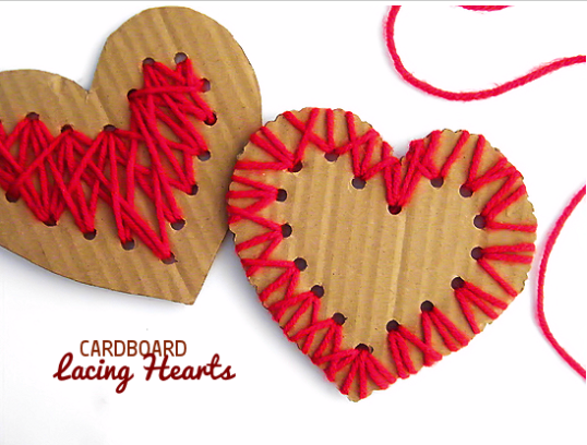 Two heart shape cardboard 1 with a red yarn around the edge and the other one is with a red yarn on the middle 