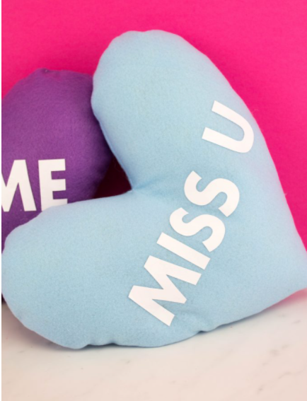 heart shaped pillows that look like conversation hearts and say things like Miss U on them