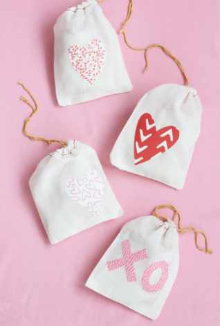 muslin drawstring treat bags with hearts and XO printed on them