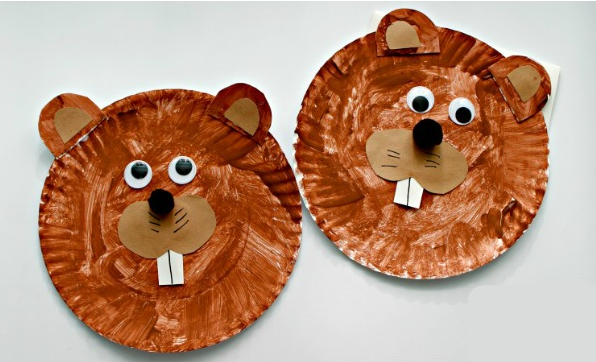 groundhog faces made from painted paper plates with construction paper features