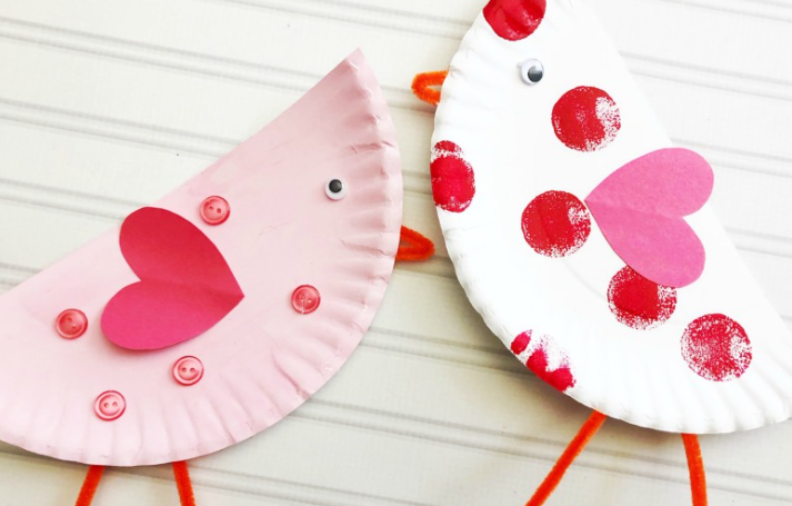 Paper plate love birds one is a color white with red paint circles and pink heart shape the other is a color pink with a red heart shape and color pink buttons on it