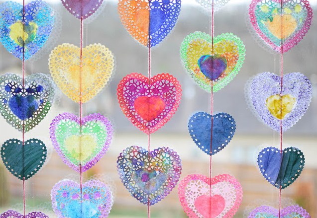 Heart shape doilies painted in different lovely colors string onto a garland