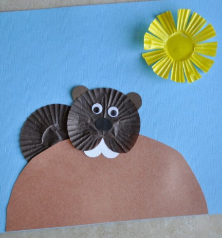 groundhog made from cupcake liners with cupcake liner sun and paper hill