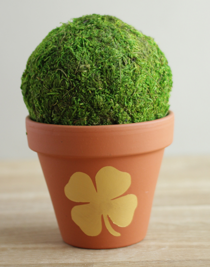 Flower pot with a metallic gold shamrock on the middle 