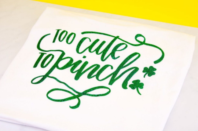 A St. Patrick's Day Iron On T- Shirt with a word says too cute to pinch