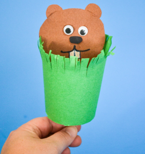 paper groundhog puppet popping out of grassy paper tube