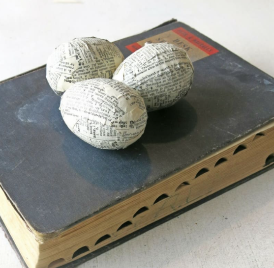 Plastic Easter eggs wrap with vintage book pages