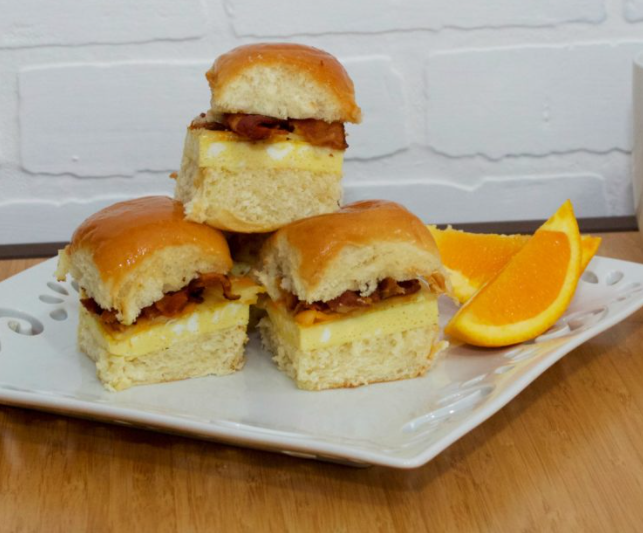 Three breakfast sliders with sliced of orange on the side easy to make for mother's day