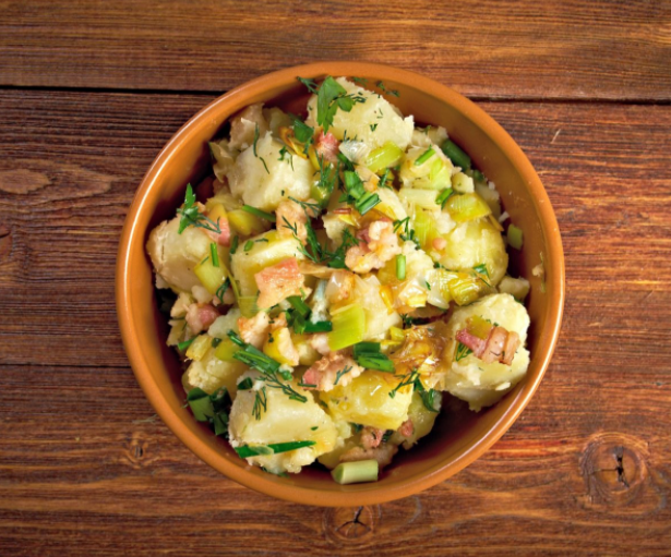 classic potato salad made with mayonnaise. With vinaigrette on it and lots of bacon