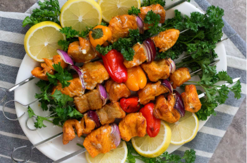 Healthy and delicious grilled salmon shish kabobs with lemons on the sidde